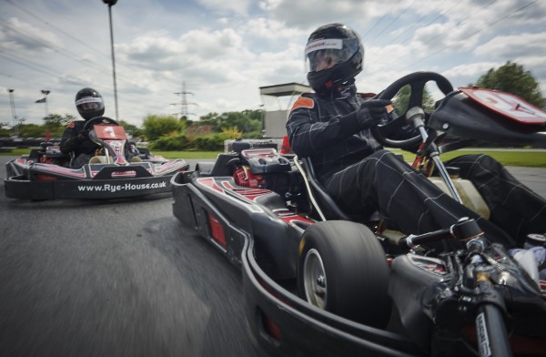 adults racing on go karts
