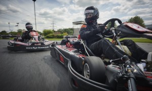 adults racing on go karts